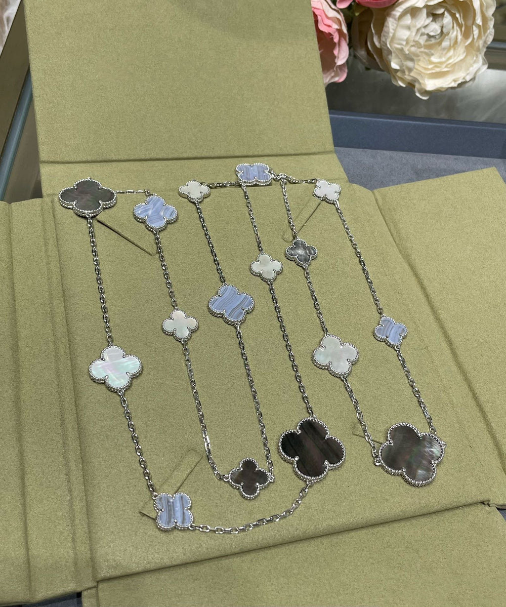 {
  "Cyra": "CLOVER 16 MOTIV HALSKETTE AUS CHALCEDON, PERLMUTT UND SILBER"
}